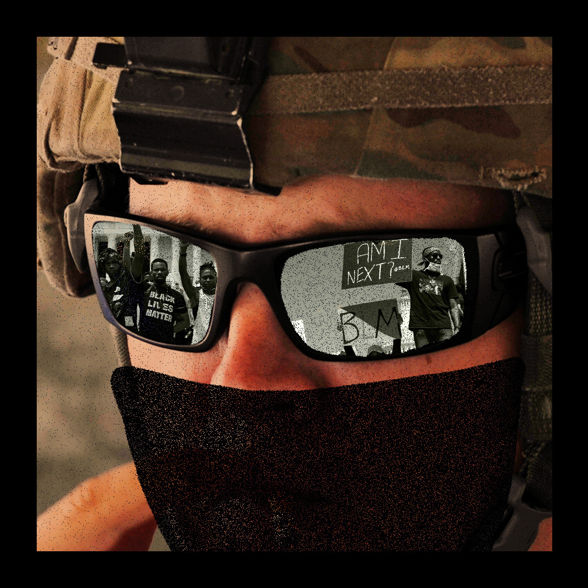 Closeup on the face of a masked U.S. federal agent in military gear. Black Lives Matter protestors are seen reflected in the agent's sunglasses.